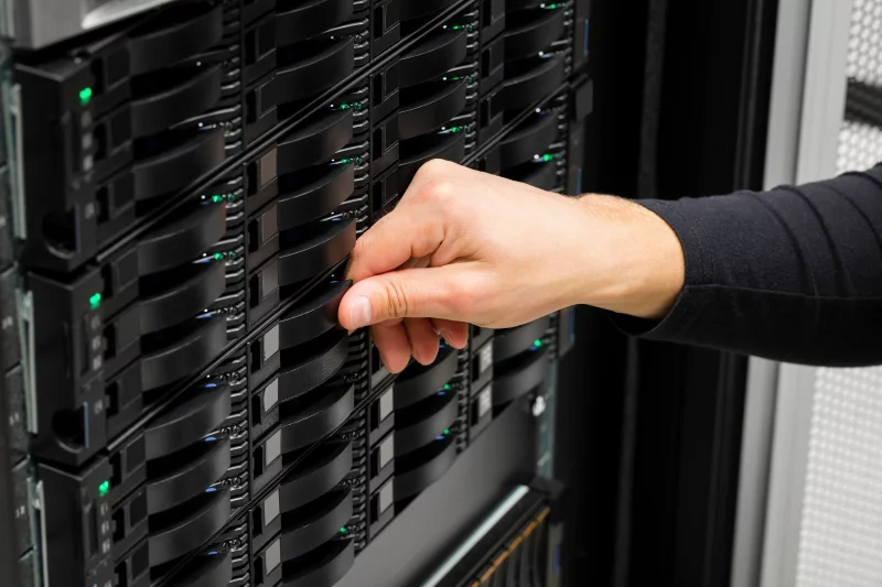 IT Engineer’s Hand Replacing Hard Drive In Data Center